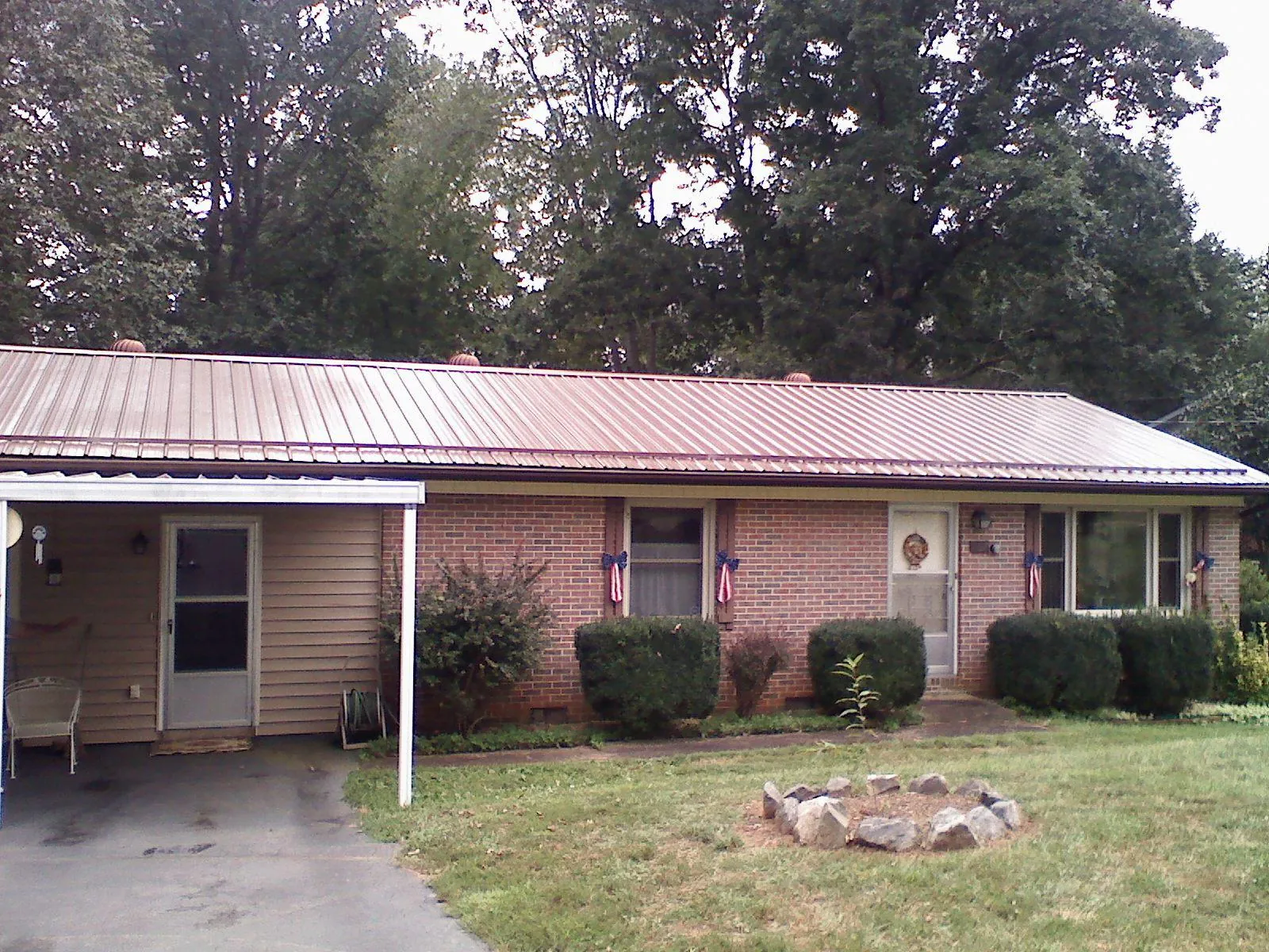 Bronze metal roof and carport on a brick ranch home — Roof Repair work by our crew in Woodstown